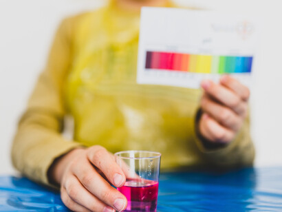 A water sample is compared to a chart by a child performing simple tests 