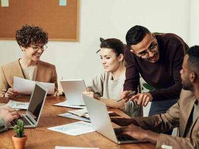 Office workers focused on digital tasks, reflecting the quiet rise of unmonitored AI adoption