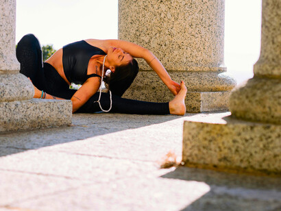 A woman practicing yoga in a building setting