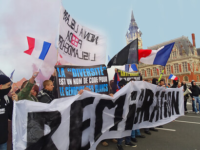 French radical right protesters in Calais on 8 November 2015, holding banners that read "Remigration" and "Diversity is a code word for white genocide"