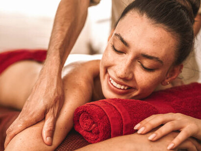 Alternative medicine: An Ayurvedic therapist gently massages a joyful woman, bringing both healing and laughter