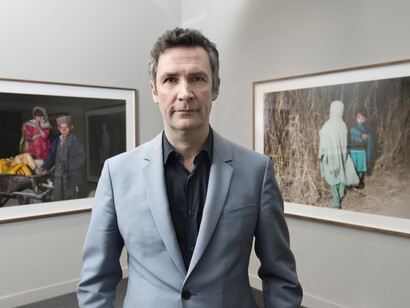 Artist Mark Neville in the gallery, © IWM