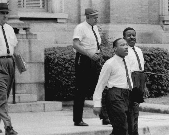 Dr. Martin Luther King, Jr. and Reverend Ralph Abernathy are escorted back to jail in Albany, Georgia, 1962. Gelatin silver print, 11 x 14 inches. © Danny Lyon, New York & Magnum Photos, New York / Courtesy Edwynn Houk Gallery, New York.