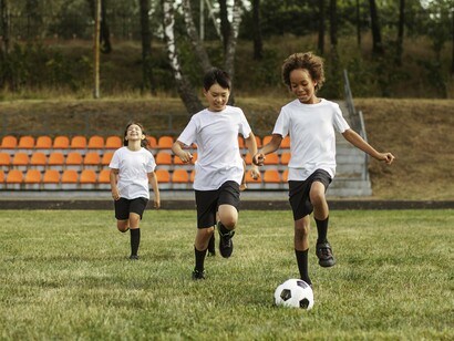 Young players chasing the ball with enthusiasm, symbolising the joy and freedom at the heart of youth sport