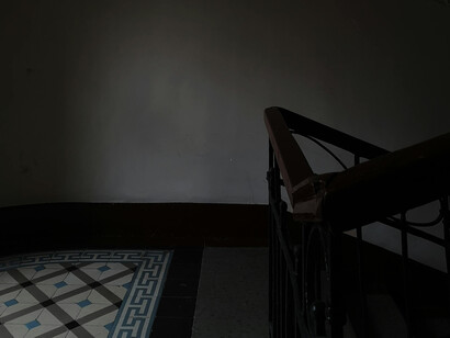 Worn tiles of a staircase landing