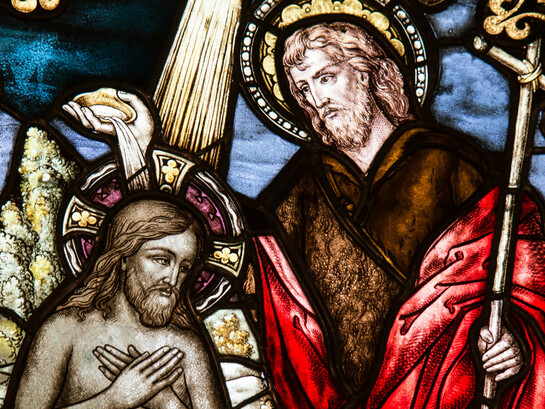 Stained glass artwork depicting Jesus Christ, part of the ornate church décor