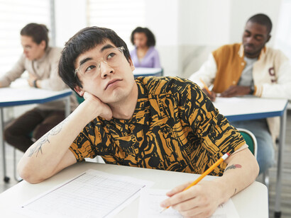 A stressed student deep in thought during an examination