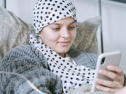 A patient is resting in bed while being treated for sickle cell disease