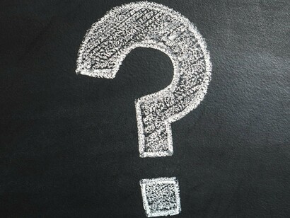 A large white question mark drawn on a black chalkboard, emphasizing how the information revolution has raised more questions than ever before