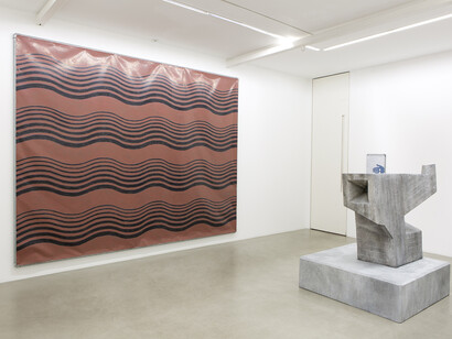 Valentin Carron - Père et fils, 2014, Vinyl ink on pvc tarpaulin, galvanised steel tubing, metal wire, 300 x 380 cm - The great object (after André Gigon), 2014
Polystyrene and resin, 161 x 130 x 130 cm - Main bleue bougie blanche, 2014, Vinyl ink on pvc tarpaulin, galvanised steel tubing, metal wire, 47 x 37 cm, View of the exhibition « L’autoroute du soleil à minuit », kamel mennour (47, rue Saint-André des Arts), Paris, 2015 © Valentin Carron, Photo: Fabrice Seixas, Courtesy the artist and kamel mennour, Paris