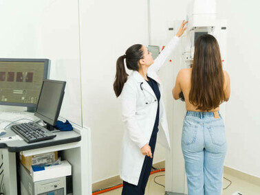 A patient receives a mammogram at an imaging center, utilizing artificial intelligence (AI) to improve the accuracy of breast cancer detection and diagnosis