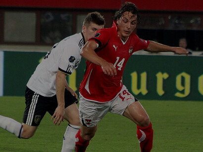 During UEFA Euro 2012 qualifying on June 3, 2011, Austria (red) played against Germany (white) in Vienna's Ernst-Happel-Stadion, with the final score 1:2 (0:1). Pictured are Toni Kroos (FC Bayern München) and Julian Baumgartlinger (FK Austria Wien)
