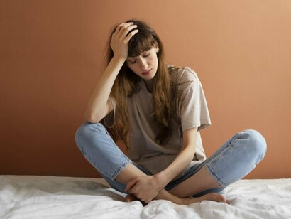 A young woman lost in thought, representing the emotional weight of fear and anxiety