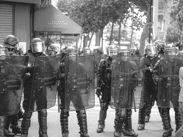 A group of police officers in a modern city, representing a police state, France 