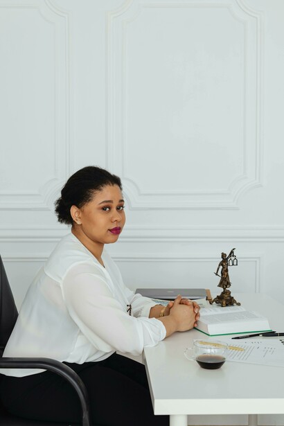 A female lawyer is seated at her desk, reviewing important paperwork