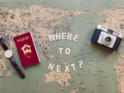 With a passport in hand and a world beneath it, the act of moving becomes both literal and symbolic