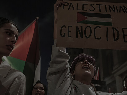 Woman in a demonstration related to Israel's 2023 invasion of Gaza, holding a cardboard that reads "This is genocide", United Kingdom