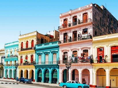 Brightly colored colonial buildings alongside classic American cars—a glimpse into the unique sense of time displacement and rich culture that defines the Cuban capital