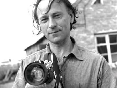 Jonas Mekas showing us his weapon of choice a deadly camera