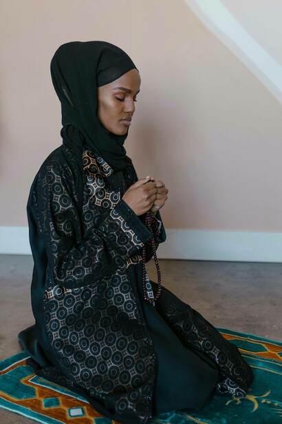 Muslim woman with rosary beads in hand