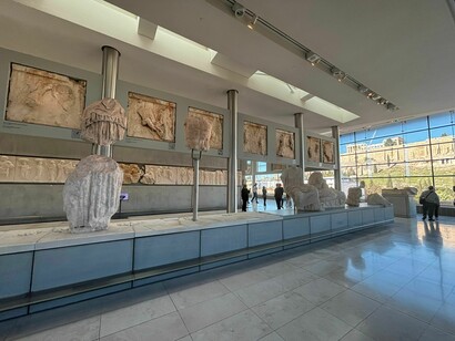 View of the third-floor exhibition space, Acropolis Museum, Athens, Greece, with a panoramic view of the Acropolis and Parthenon, including the pediment sculptures of the Parthenon on display