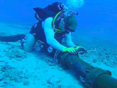 An underwater diver repairing an underwater power cable