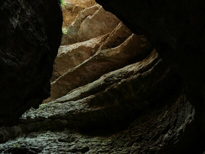 Caverna com feixe de luz. Certo dia, um prisioneiro consegue se libertar e, quando vê o mundo fora daquele limitado espaço, fica surpreso. Um impasse o domina. Voltar ou não para aquele agrupamento com quem vivera e contar para seus companheiros que existia um mundo diferente? 
