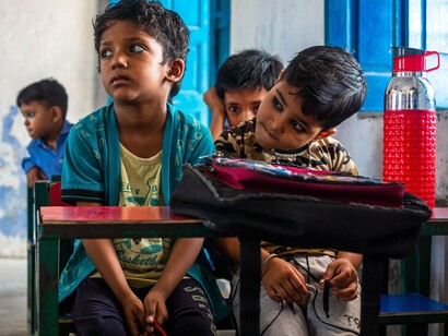 Students gathered at their desks during a lesson, reflecting how everyday pursuit of knowledge can break cycles of poverty and inequality
