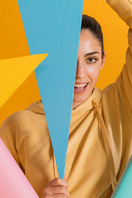 Happy woman surrounded by vibrant geometric shapes, illustrating the impact of color psychology on mood