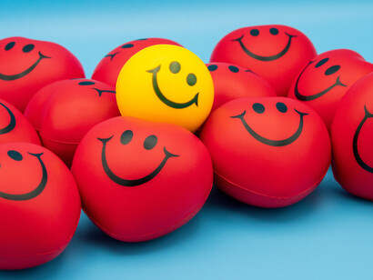 Yellow and red balls with smiley faces signifying happiness