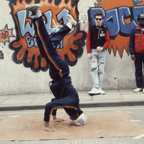Beezer, Bristol BBoys head spinning in front of 3D's and Z Boys’ Wild Bunch Rocit, 1983, photographic print on paper, Broadmead, Bristol, 21 x 29.7cm
