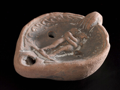 Terracotta lamp with lug handle and moulded design, Courtesy of Science Museum / Science and Society Picture Library