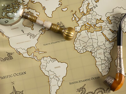 Arranged on the table are pirate artifacts, an antique map, an ornate pipe, and a vintage magnifying glass, inviting you into the world of maritime exploration