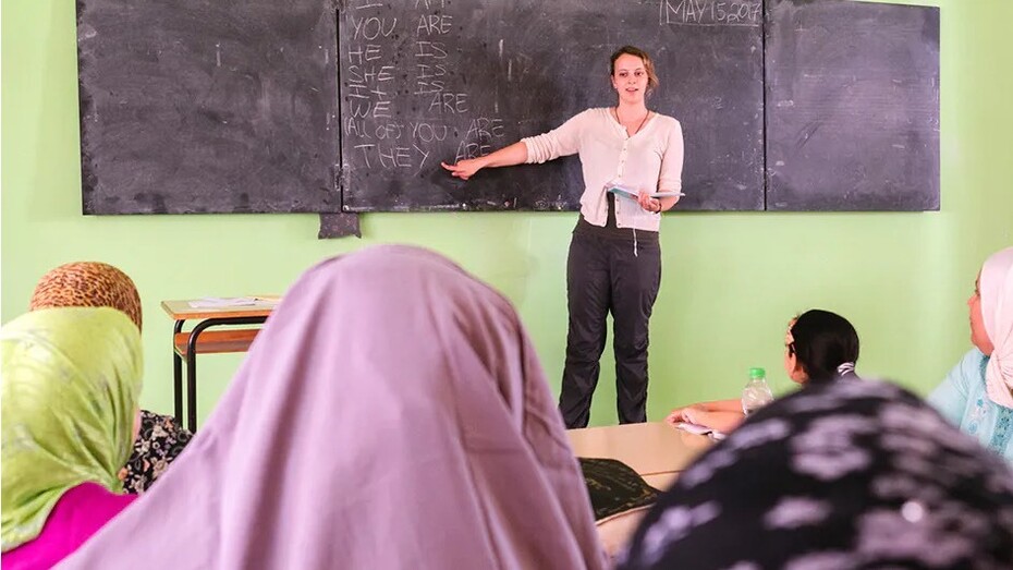 A volunteer worker teaching English in Morocco. Learning foreign languages, such as French and English, has given Moroccans access to different cultural viewpoints and improved the nation's capacity for cultural adaptation