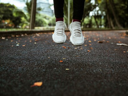 Person warming up for a run in the park 