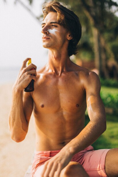 A person applying sunscreen before spending time outdoors, representing the importance of proactive sun protection in reducing skin cancer risk