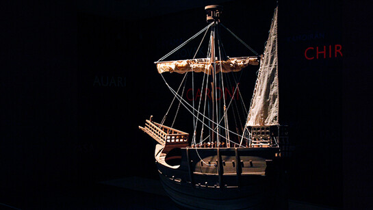 Lothar Baumgarten, Los Aristócratas de la Selva y la Reina de Castilla, 2011-2012, 4 ship models, (C. Columbus) Santa María, Pinta, Niña, Coca de Mataró, Wall drawing of 250 South American river names, 3.5 hour sound piece, looped + 
6 films, color and black/white, sound (Yãnomãmi) (108 min.). Dimensions variable