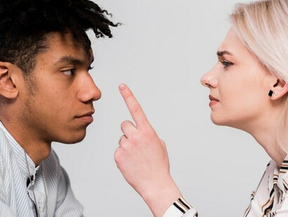 A tense exchange between an interracial couple, symbolizing the challenges of diversity and intercultural communication