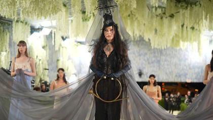 Madonna in custom Saint Laurent by Anthony Vaccarello, wearing a dramatic black lace ensemble with a sculptural ship-inspired headpiece and flowing veil during the 2026 Met Gala