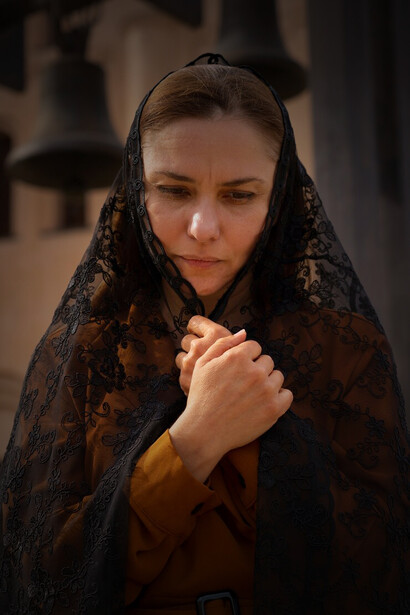 A woman participates in a religious pilgrimage at the church