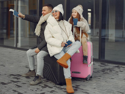 A family preparing for an international move, standing outdoors with luggage and checking passports, embracing the challenges of expat life