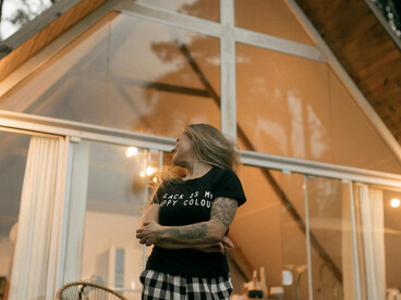 A peaceful wooden A-frame cabin nestled in the mountains, capturing the essence of offline travel, silent retreats, and slow living in nature