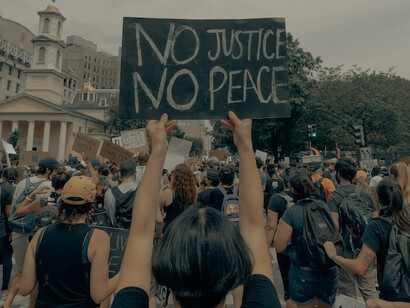 On June 6, 2020, in Washington D.C., a woman prominently raises a sign during the "Black Lives Matter" protest