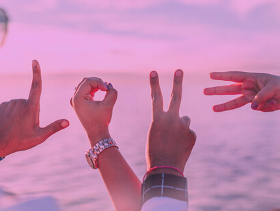 Friends use their hands to spell out love