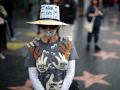 A "Me too!" marcher on Hollywood Blvd Sunday to end sexual harassment in the workplace