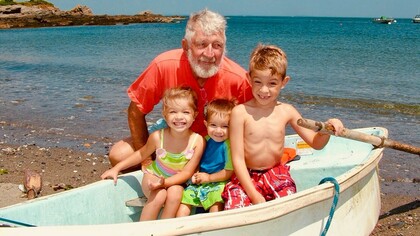 Farfar posing with his grandchildren on his old rowboat