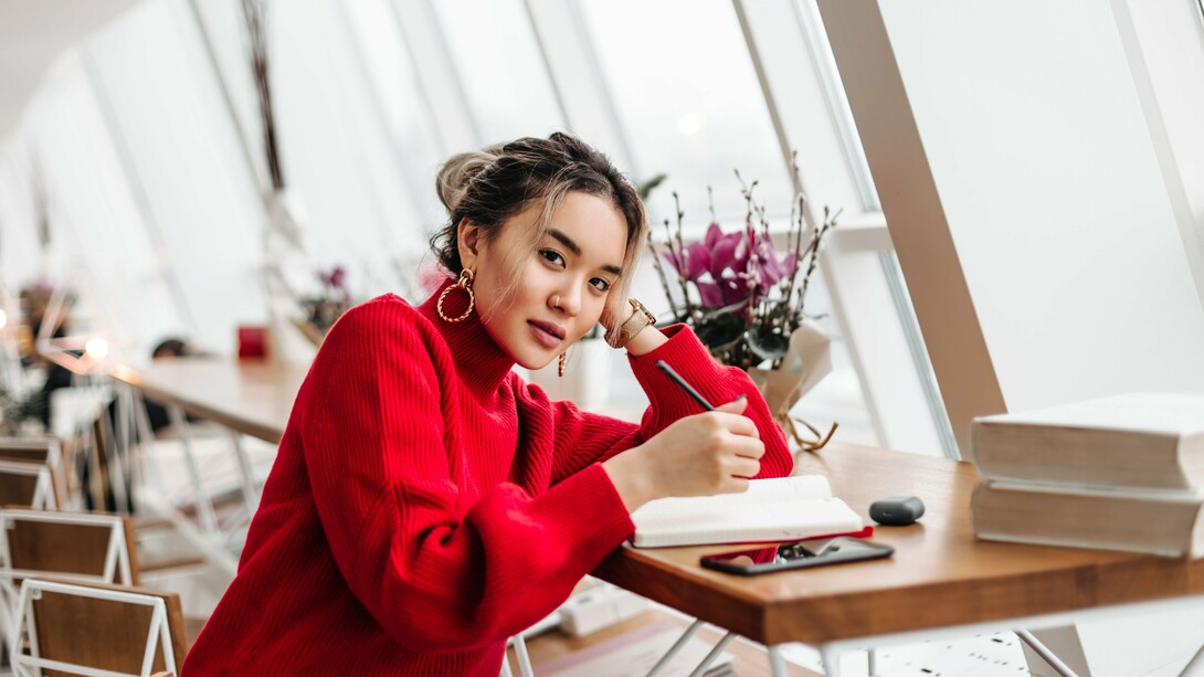 A woman writing in her diary, representing the quiet rebellion of self-expression