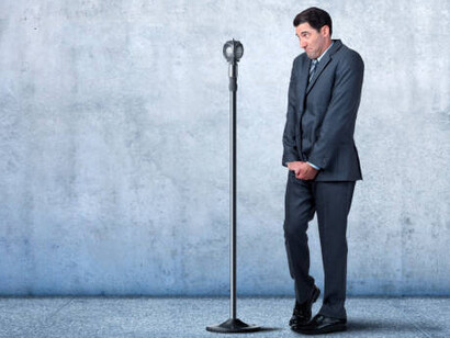 A businessman overcomes the fear of public speaking, reflecting courage and a journey of personal growth