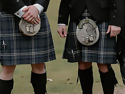 Scottish men wearing traditional kilts