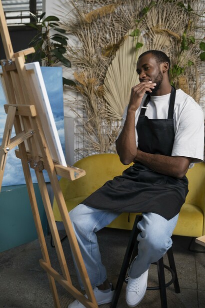 An African artist painting, representing the evolution of traditional creativity into contemporary artistic expression